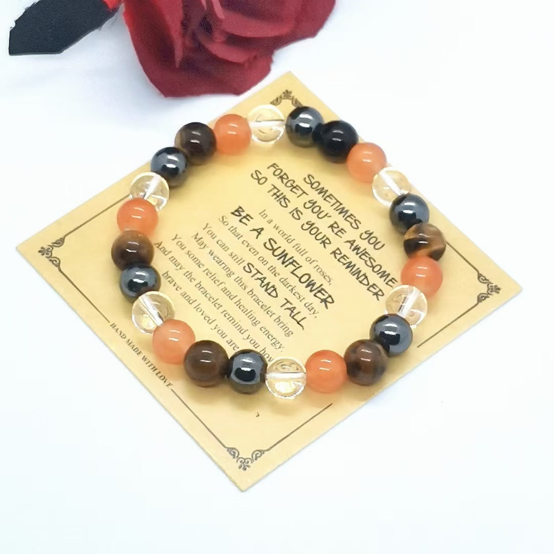 Multicolored beaded bracelet on a decorative card with text, against a white background.
