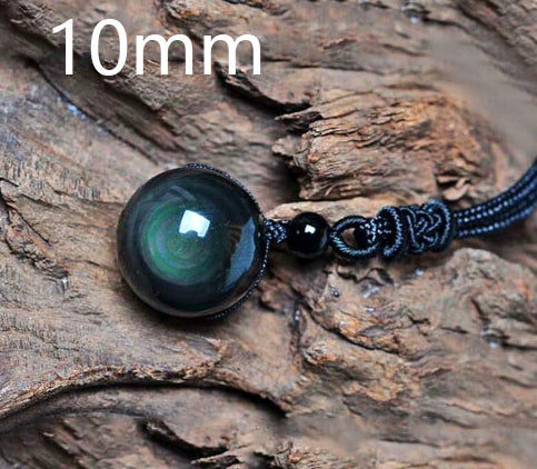 Necklace with a large green stone on a wooden surface, labeled '10mm'.
