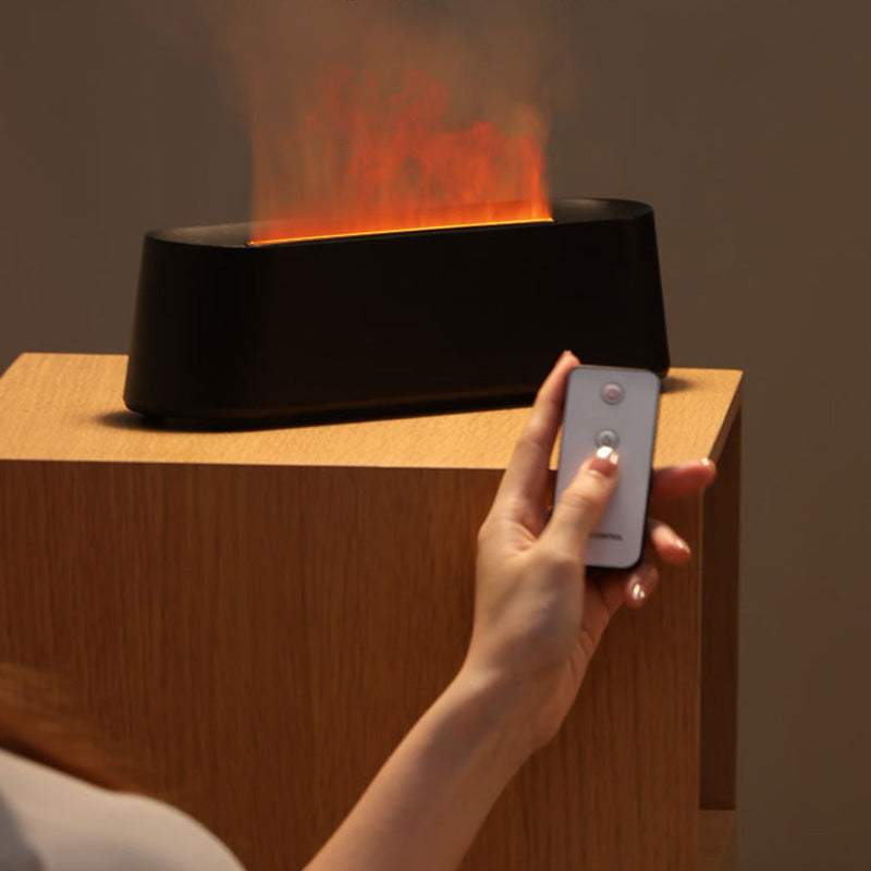 Hand holding a remote control over a digital fireplace