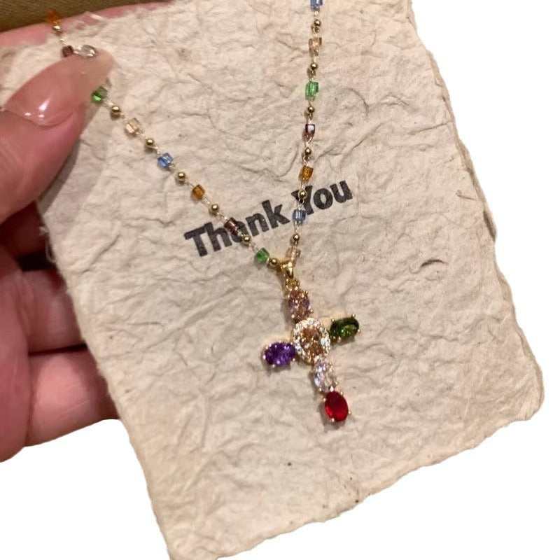 Necklace with colorful beads and a cross pendant on a 'Thank You' card.