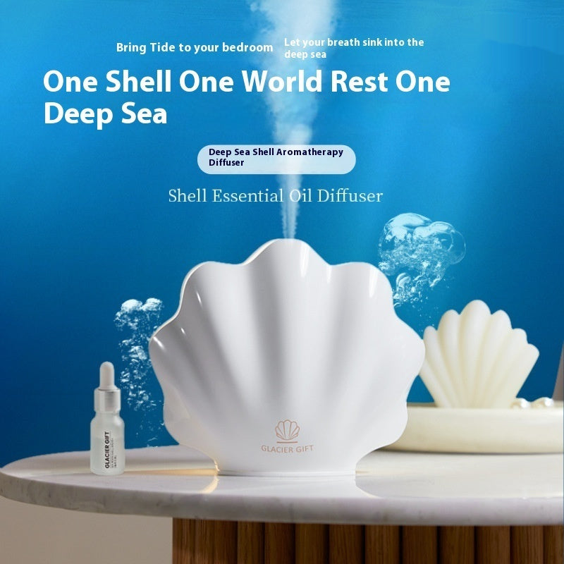 Shell-shaped essential oil diffuser with a bottle on a blue underwater-themed background