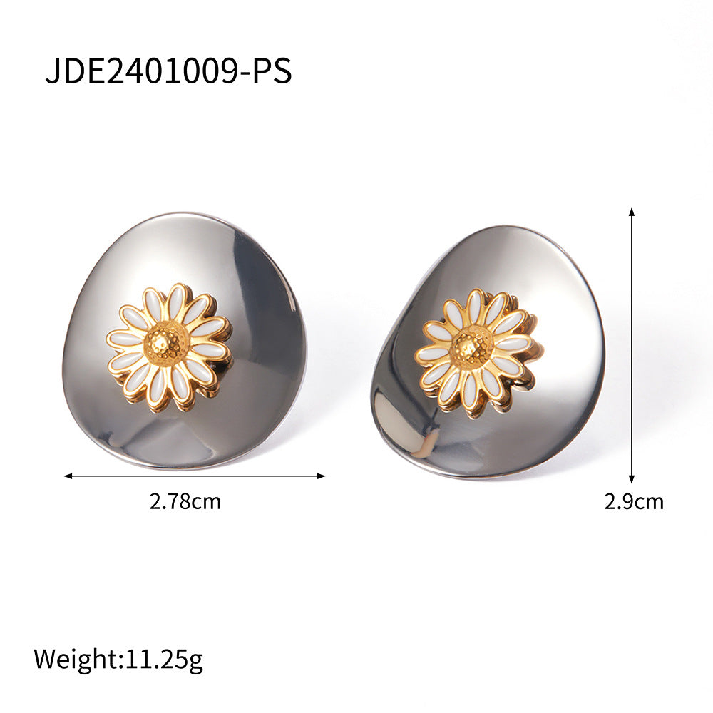Pair of earrings with gold flower designs on a white background